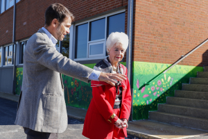 Dan Leroy shows the progressing mural on the UWABC building. 