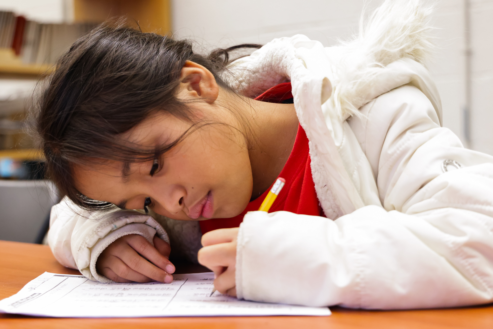 A PODS program student works dilligently in her afterschool program at the Edington Center. 