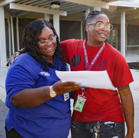 Community School Coordinator, Shataura Dudley, greets a friend. 