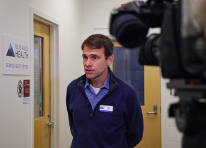 CEO of United Way of Asheville talks to reporters about School Based Health centers.