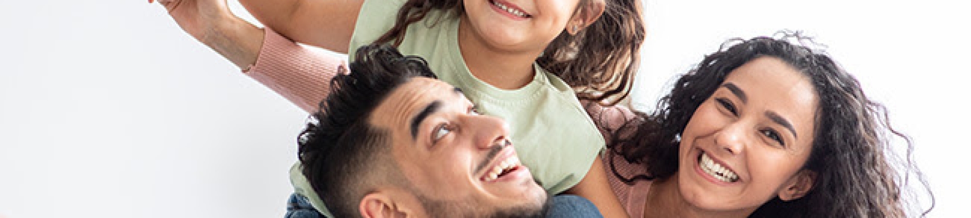 family with little girl on shoulders