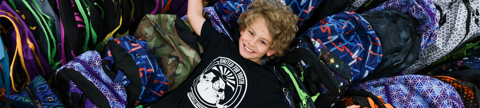 Student enjoying the gift of a Backpack.
