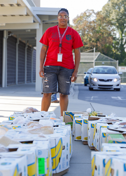 Community School Coordinators, Shataura Dudley, prepares to distribute food boxes.